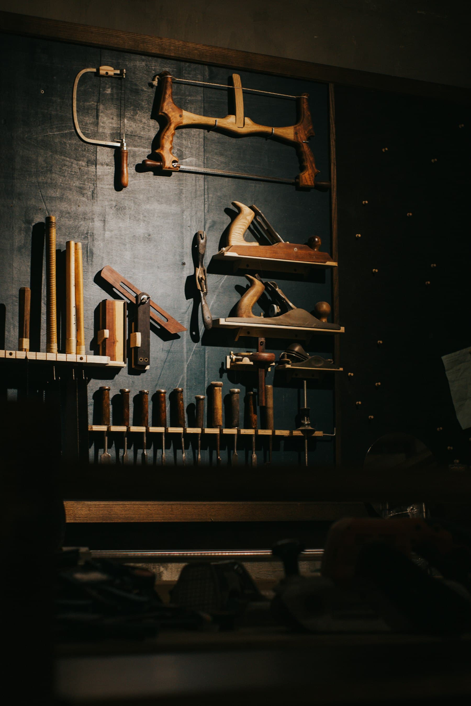 Hand tools hanging on a workshop wall