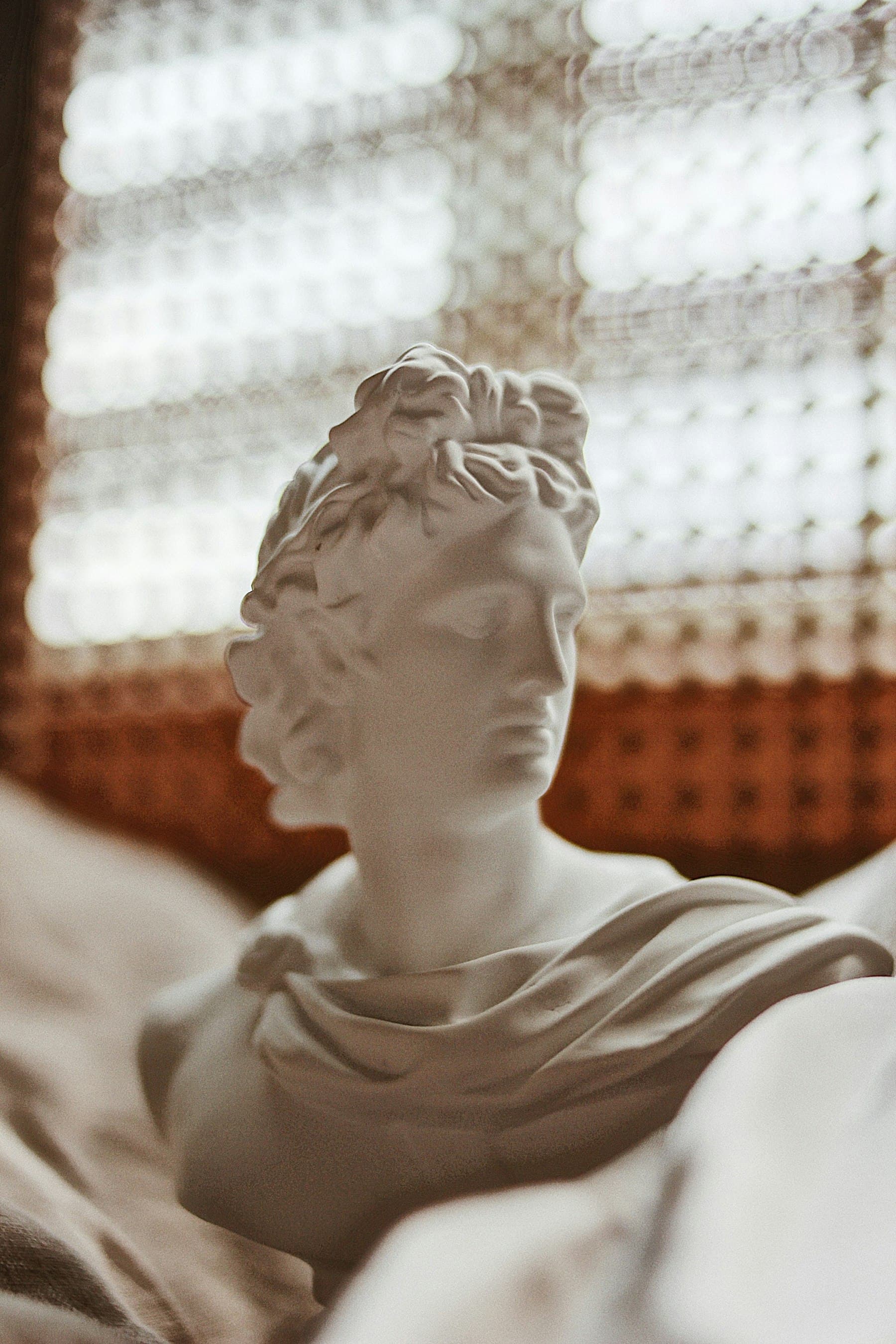 A classical marble head, eyes lowered